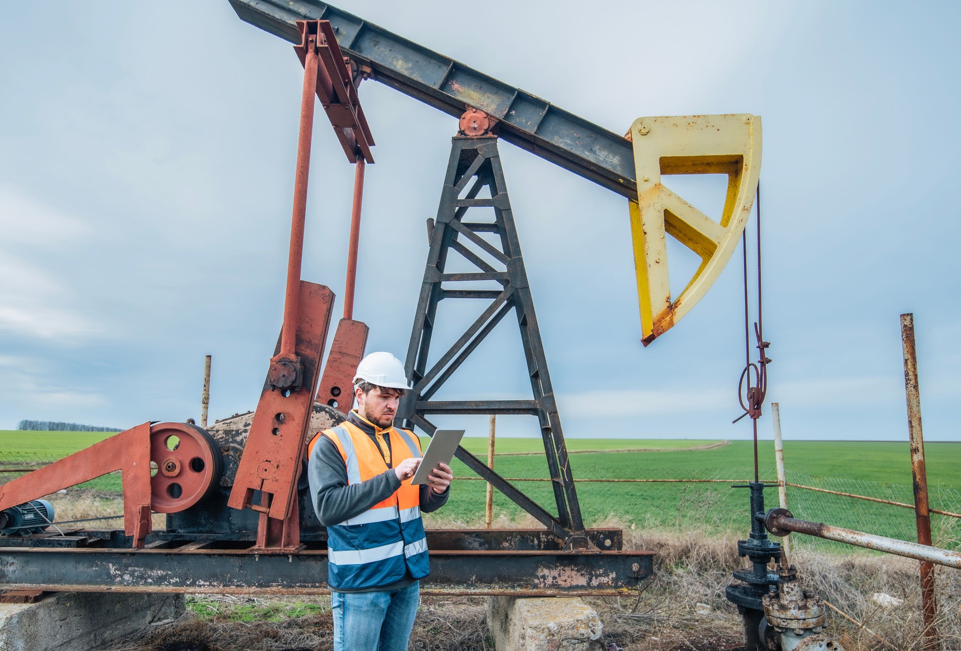 Oil extraction engineer inspecting oil pump.