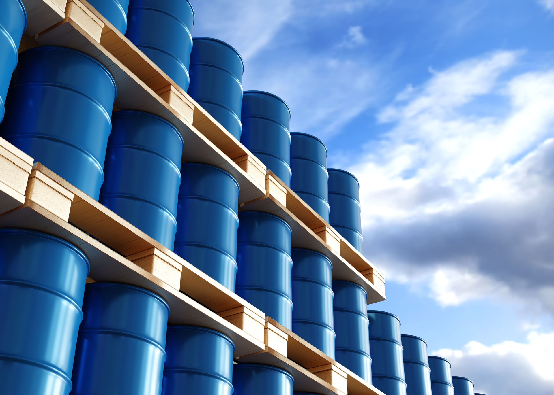 Blue barrels on the pallets contain petroleum in warehouse prepare for delivery