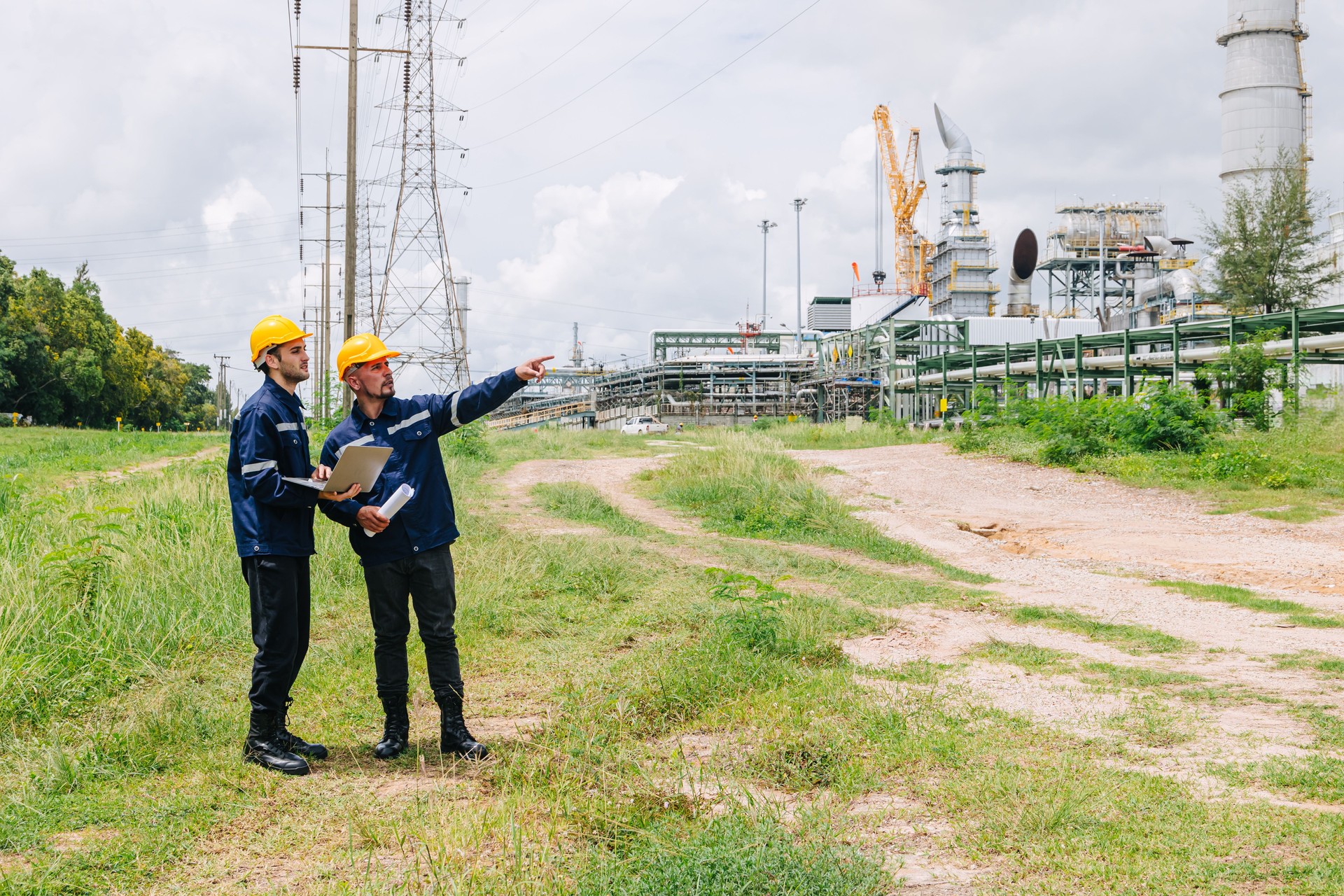 Engineer worker team working outdoor, Surveyor teamwork survey gas pipe oil transport pipeline deploy building project for refinery industry.